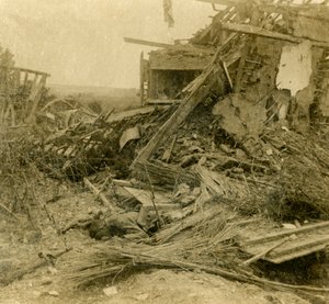 Bombed out building, body of dead soldier in foreground by Unbekannt