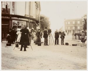 Group of photographers taking photographs in the street by Unbekannt
