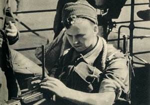 Royal Marine checking his machine gun, World War II