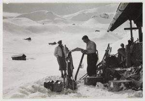 Skiers outside a chalet, c 1930 by Unbekannt
