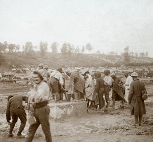 Soldiers queuing in the mud for water, Genicourt, northern France by Unbekannt