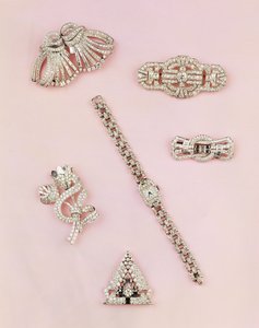 Selection of diamond jewellery: baguette and marquise-shaped diamond spray brooch; Art Deco diamond clip; panel diamond brooch; lady