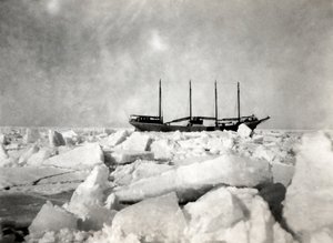 A four-masted ship sailing among the icebergs