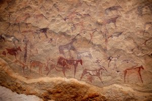 Rock art, Prehistory: Rock painting of a group of cattle and polychrome characters (shepherds and archers) in an ornate shelter, in the Uweinat massif, Sudan. Period from 8000 to 3000 years BC. Photography