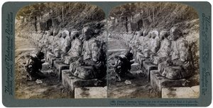 Peasant Praying Before a Row of Statues of the God of Light, Daiya River, Nikko, Japan, 1904 by Underwood and Underwood