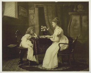 Woman and Child Playing Dominoes at Table