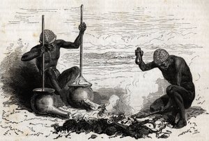 Blacksmiths Lakoutas (tribe located in the Upper Nile region), a forked wood branch serves as pliers, two stones serve as hammer and anvil, two earthen pots with long tubes at their base serve as bellows for charcoal fire, the pots are firm by a piece of s