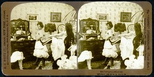 Stereoscopic card depicting a woman being laced into a corset, c.1900