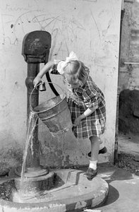 Little Girl Emptying a Bucket of Water in a Pump Fountain, 9th May 1939