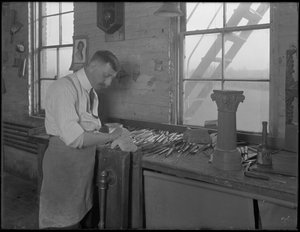 Carver working on casket ornaments, Oneida, New York, April 3, 1916