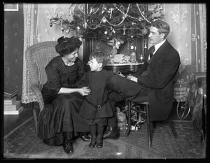Dan Seymour and family in informal pose, seated beneath a Christmas tree, Christmas 1912