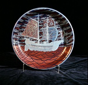 Charger with silver lustre, with a galleon sailing on a red lustre sea