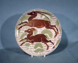 Plate decorated with two running antelope in ruby red lustre on cream-coloured earthenware, late 19th century