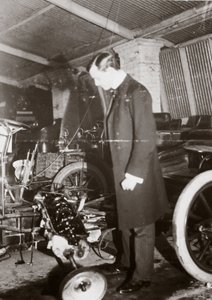 C. S. Rolls Looking at the Engine of a Motor Car in His Garage, c. 1900
