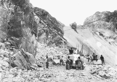 Excavators at work at a marble quarry in the Apuan Alps, Tuscany. Some of them are seated on blocks of marble already squared off. by A. Corsini