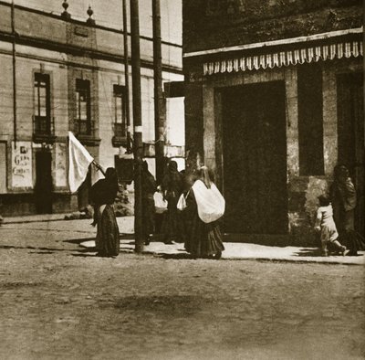 Women walking in the streets under the cover of a white flag during 