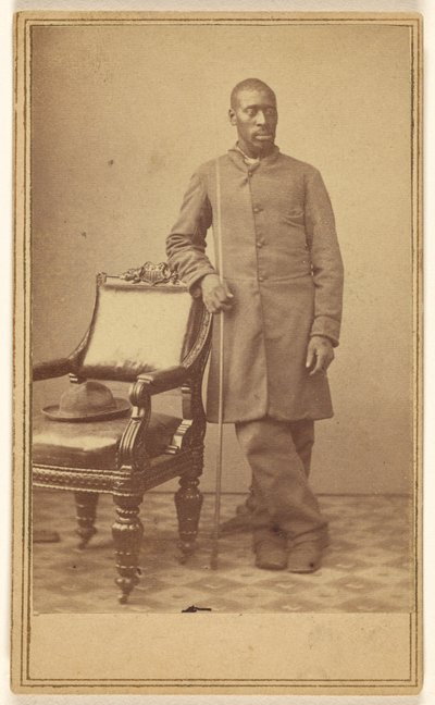 Black Soldier Standing Near Chair with Hat in Seat by Alexander Gardner