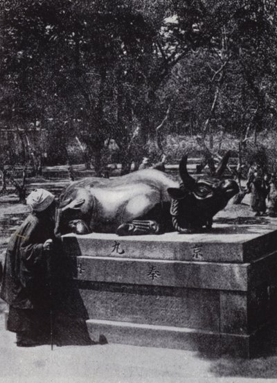 Devout woman stroking a bronze bull by American Photographer (after)
