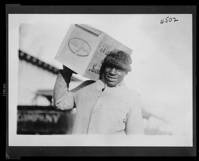 African American Man Carrying a Case of 