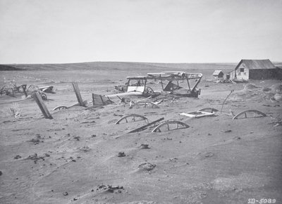 Car and farm machinery buried by dust and sand, Dallas, South Dakota by American Photographer