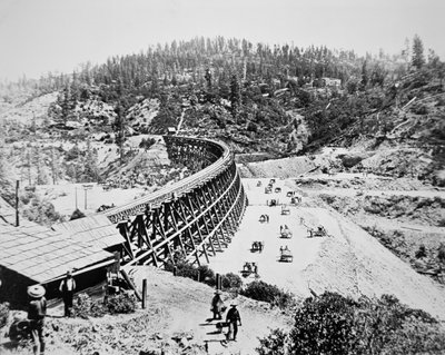 Chinese labourers working on a trestle bridge on the western slope of the Sierra Nevada mountains by American Photographer