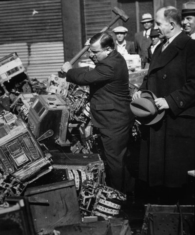 Fiorello La Guardia (1882-1947) smashing confiscated slot machines by American Photographer