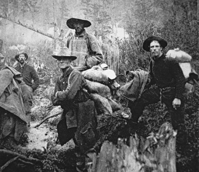 Gold prospectors on the move to Yukon Territory, Canada, during the Klondike Gold Rush (1897-98) by American Photographer