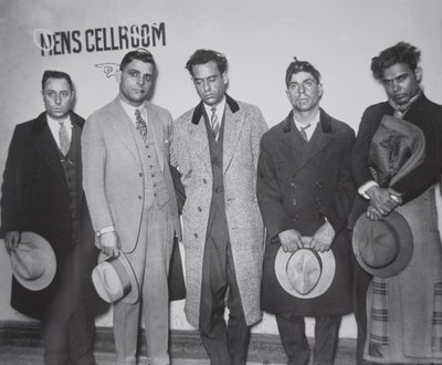 Joe Aiello (1891-1930) with his henchmen in police custody by American Photographer