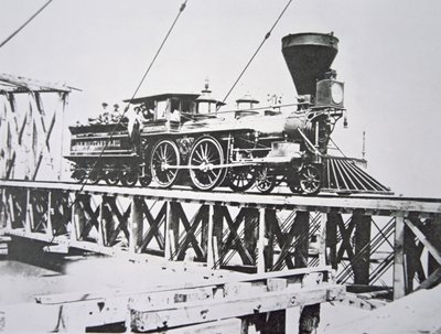 Locomotive of the US Military Railroads (Union Army) crossing trestle bridge over the Potomac River by American Photographer