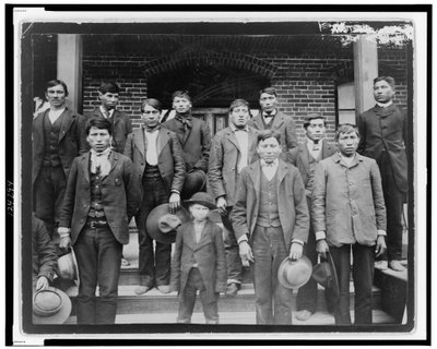 Native American Men and a Boy Posed Outside of Carlisle Indian School, Pennsylvania, c.1890 by American Photographer