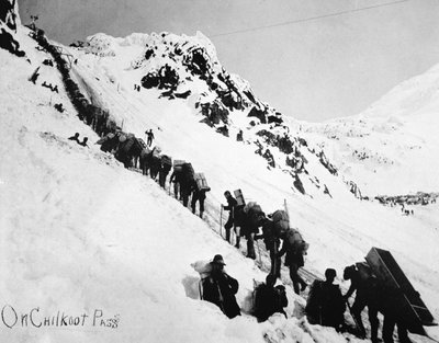 Prospectors climbing the Chilkoot Pass during the Klondike Gold Rush (1897-98) by American Photographer