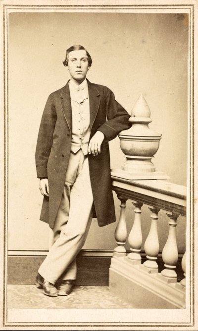 Unidentified man in top coat leaning against pillar, c.1860-75 by American Photographer