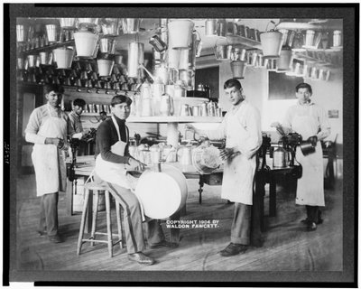Young Native American men in metalworking workshop with pails, washtubs, watering cans, and other metal items, Carlisle Indian School, Pennsylvania, c.1904 by American Photographer