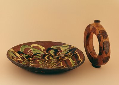Redware oval dish with marbled glaze and water carrier by American School