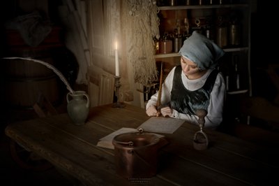Woman Writing by Candlelight by Andrzej Lisowski