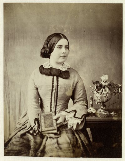 Studio portrait of an unknown woman with a book in hand by Anonymous