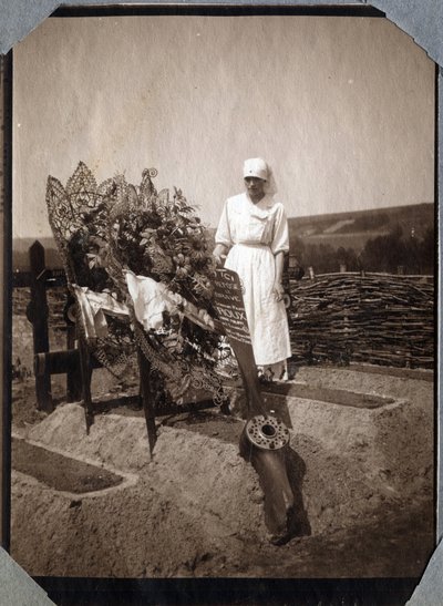 First World War 1914-1918: nurse (Therese Pavillou?) in a blouse on the grave of French pilot sergeant Roux, who died at the age of 21, at Couville, Manche, Lower Normandy, France. Anonymous photograph July 1917. Private collection, Stella by Anonymous Anonymous