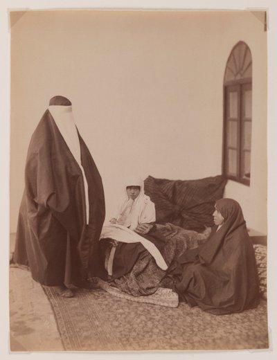 Two veiled women and a child by Antoin Sevruguin