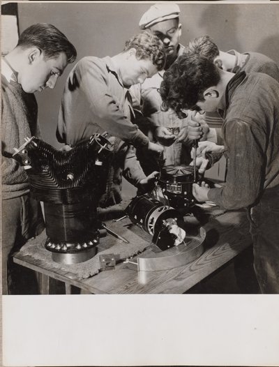 Five Young Men Work Around a Work Bench by Arnold Eagle