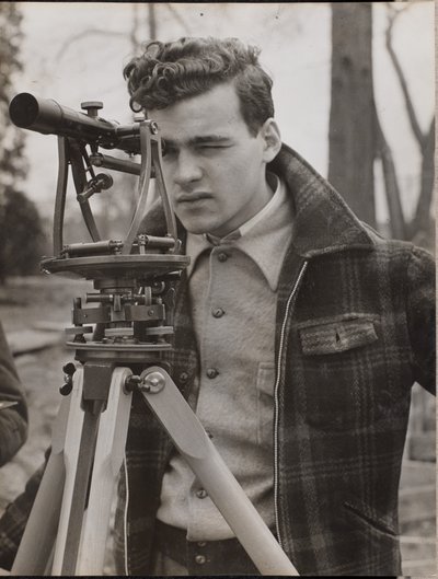 Young Man Peers Through a Surveyor