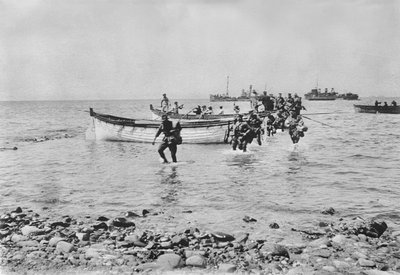 Australian Soldiers Wading Through the Water as They Come Ashore at Anzac Cove, Gallipoli on 25 April 1915 After Being Transported in Landing Boats from Larger Ships in the Background, 25 April 1915 by Australian Photographer