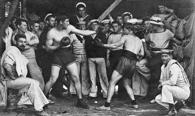 Unidentified sailors watch a boxing match in their midst aboard HMAS Melbourne, 1915 by Australian Photographer