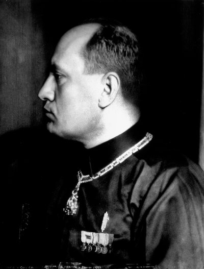 Half-length portrait in profile of Benito Mussolini in black shirt and military decorations by Brogi Brogi