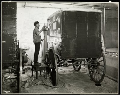 A Man Spraypainting a Delivery Wagon of the Carolyn Laundry at 111 East 128th Street, East Harlem, New York, 1929 by Byron Company