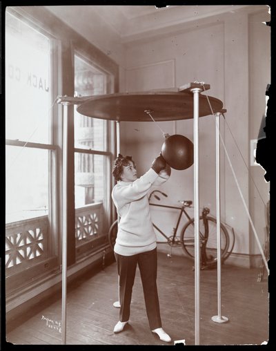 Edna Wallace Hopper hitting a punching bag at Jack Cooper