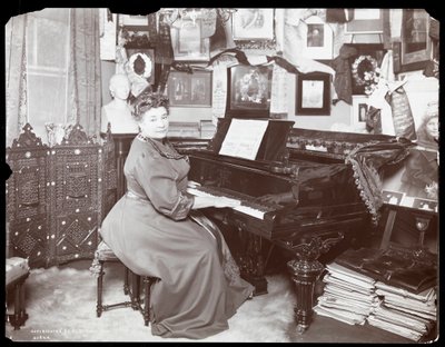 Madame Schumann Heink seated at a piano by Byron Company