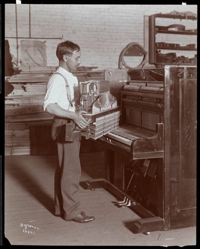 Man working in the Hardman, Peck und Co. piano factory, New York, 1907 by Byron Company
