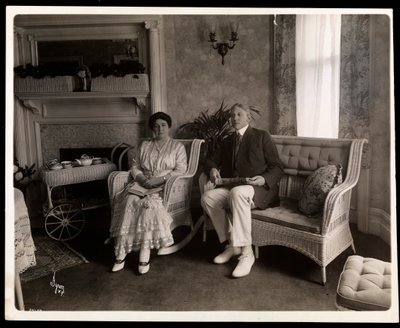 Portrait of Mr. and Mrs. Howard Seated in Their Home at 200 5th Avenue, New York by Byron Company
