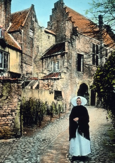 Woman in front of the Kuipers portal in the city of Middelburg, image date: circa 1920, Carl Simon Archive by Carl Simon