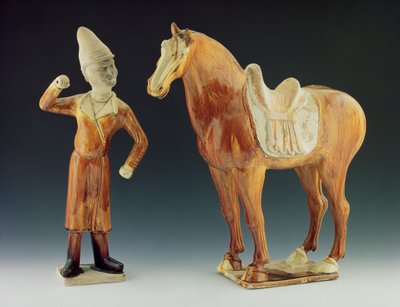 Groom figure wearing a coat and peaked hat with a saddled horse, Tang Dynasty by Chinese School Chinese School